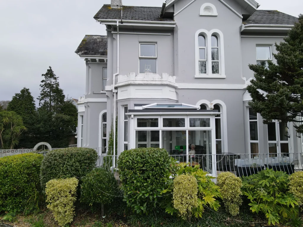 The front of Chatsworth Residential Home in Mannamead, with the conservatory and planted borders