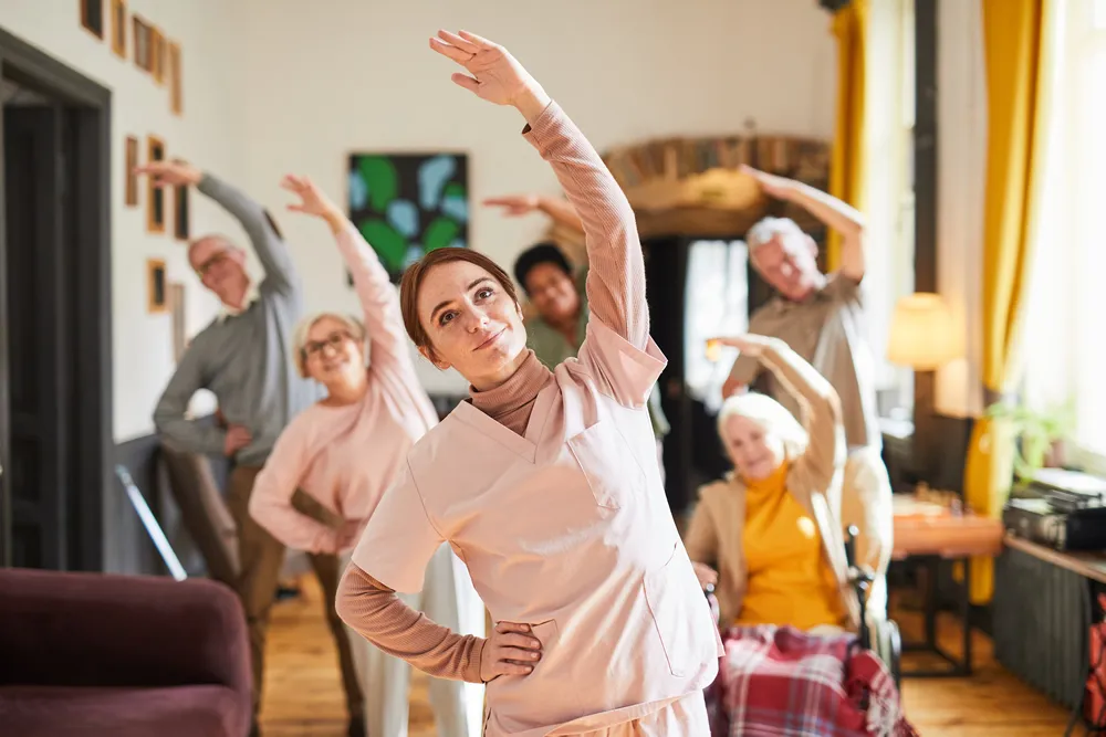 A group of older people taking part in a seated exercise session