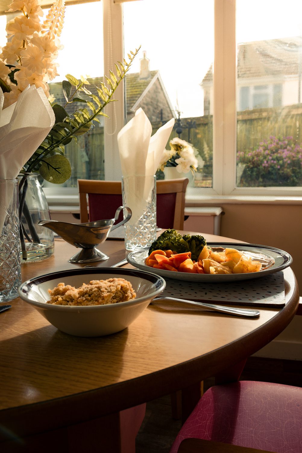 A cooked two course lunch served at a dining table by the window